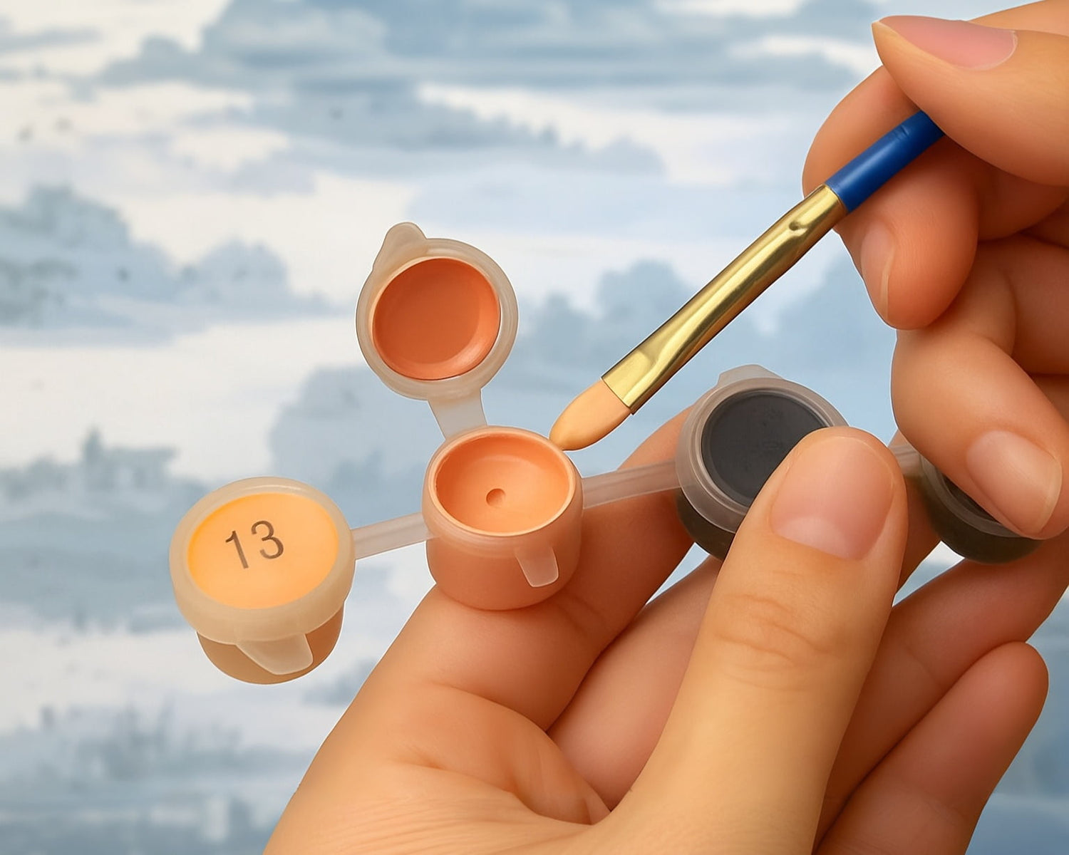Hands calmly preparing paint for a paint-by-numbers kit.