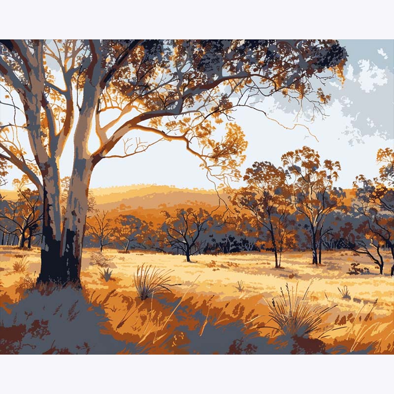 Scenic landscape with trees and open field under a clear sky