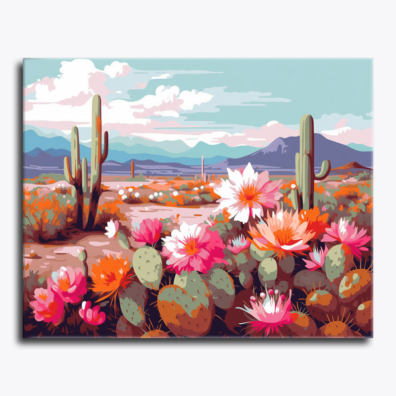 Canvas print of a desert scene with cacti and flowers against a mountainous background.