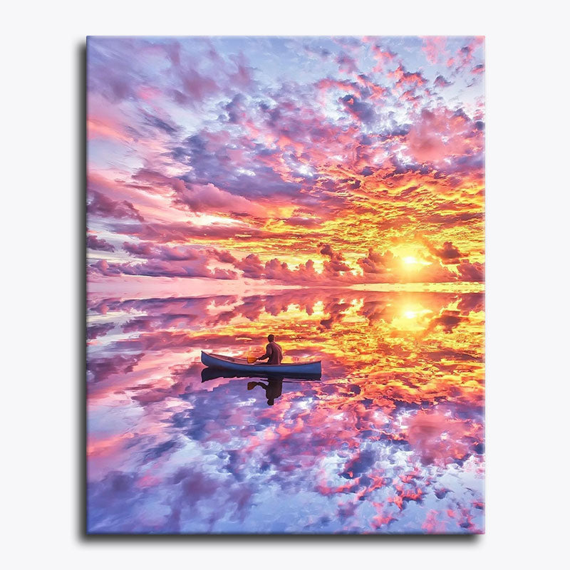 Canvas print of a person in a canoe on a lake with a colorful sunset sky.