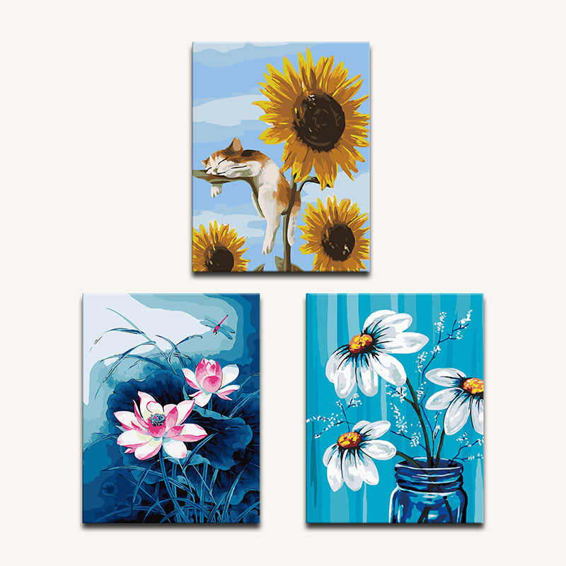 Set of three colorful paintings featuring a cat, sunflowers, and flowers with a blue background.