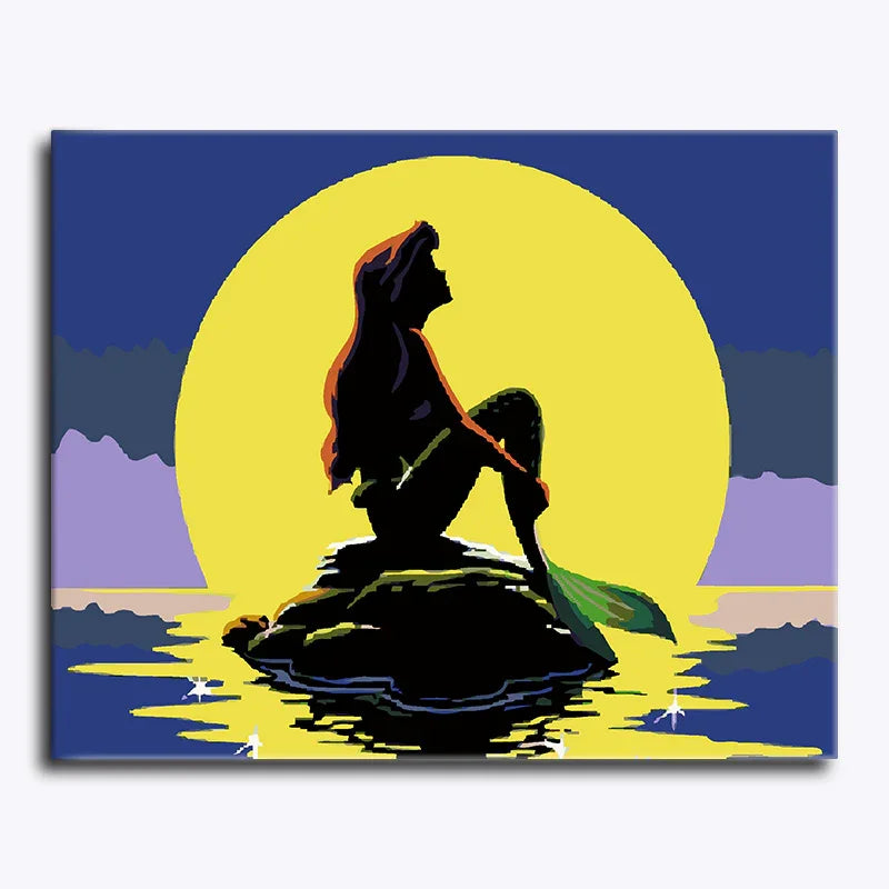 Silhouette of a mermaid on a rock with a large sun in the background