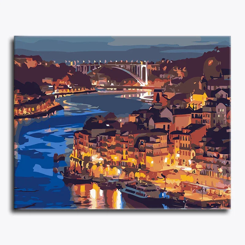 Canvas print of a coastal cityscape with boats and a bridge at night.