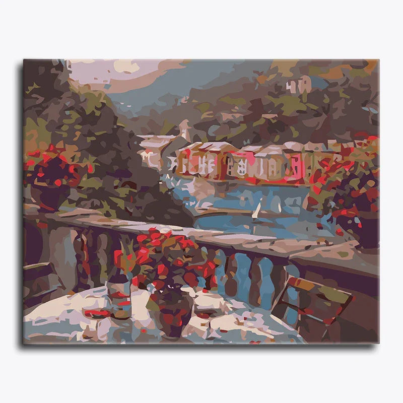Painting of a riverside scene with boats and a table with flowers and wine bottles.