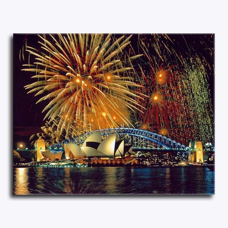 Fireworks over a bridge with a boat at night
