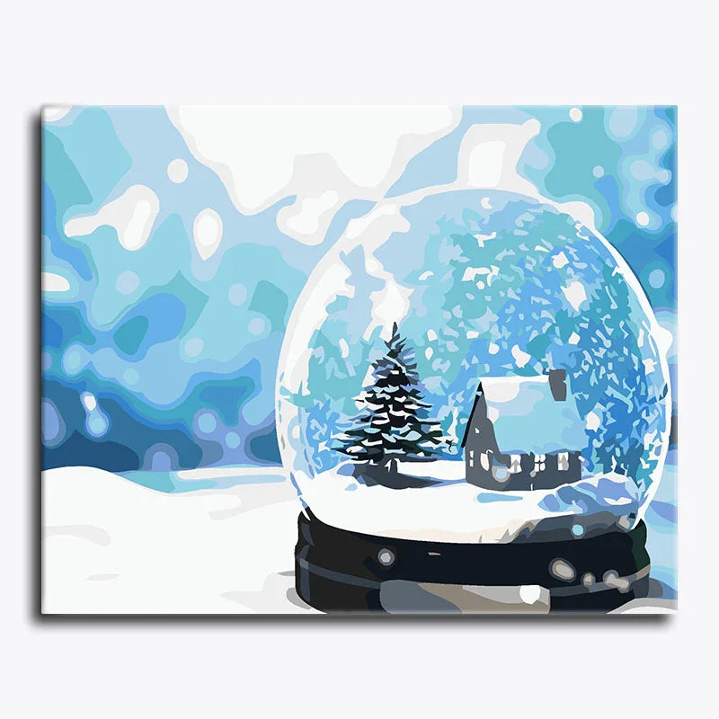 Canvas print of a snow globe with a winter scene featuring a house and tree, set against a snowy landscape.