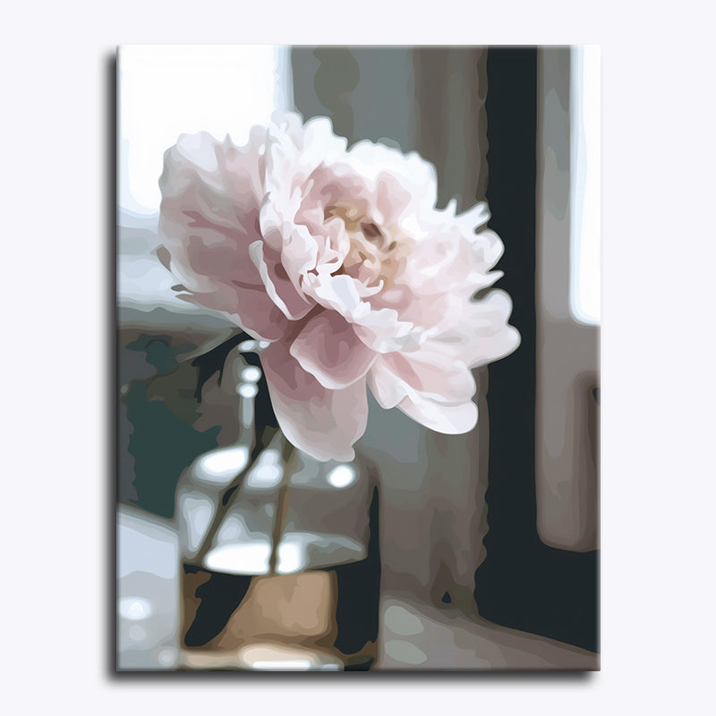 Pink flower in a vase with a blurred background