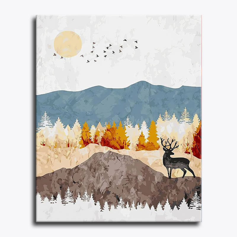 Canvas print of a deer in a forest with mountains and a blue sky.
