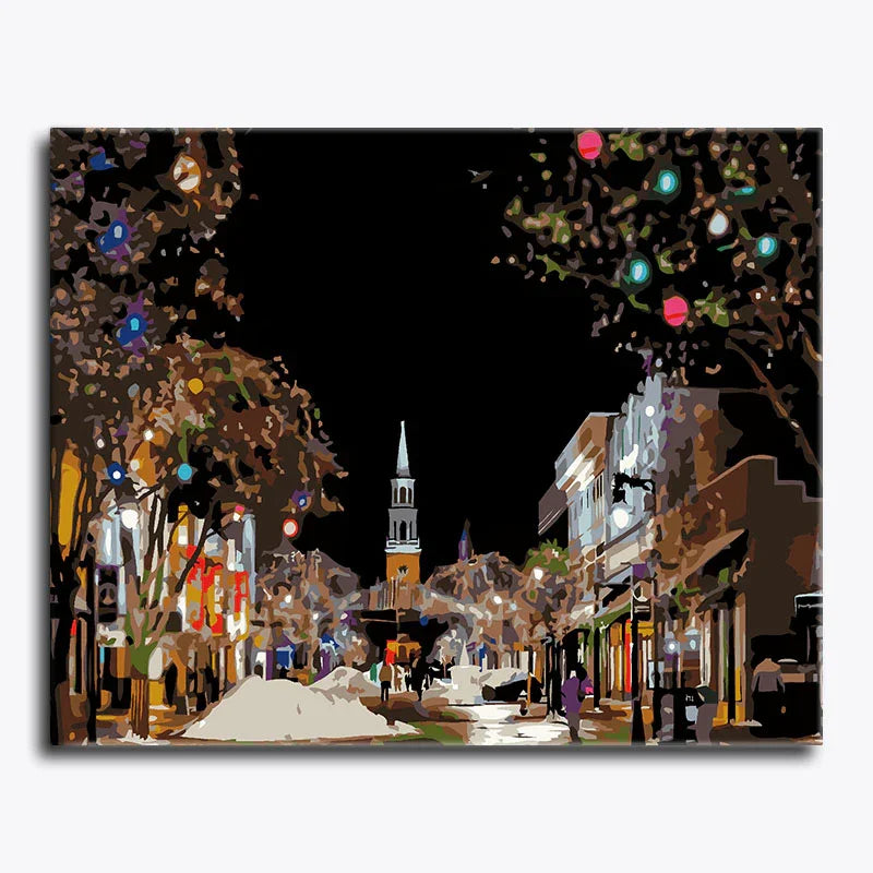 Decorative image of a city street at night with lights and buildings.