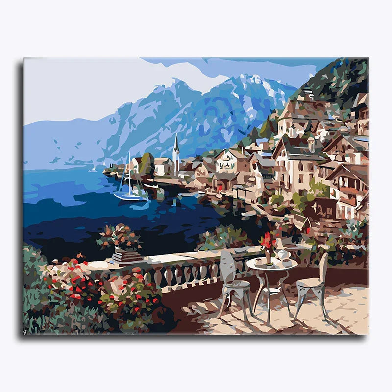 Painting of a coastal town with mountains and a sailboat.