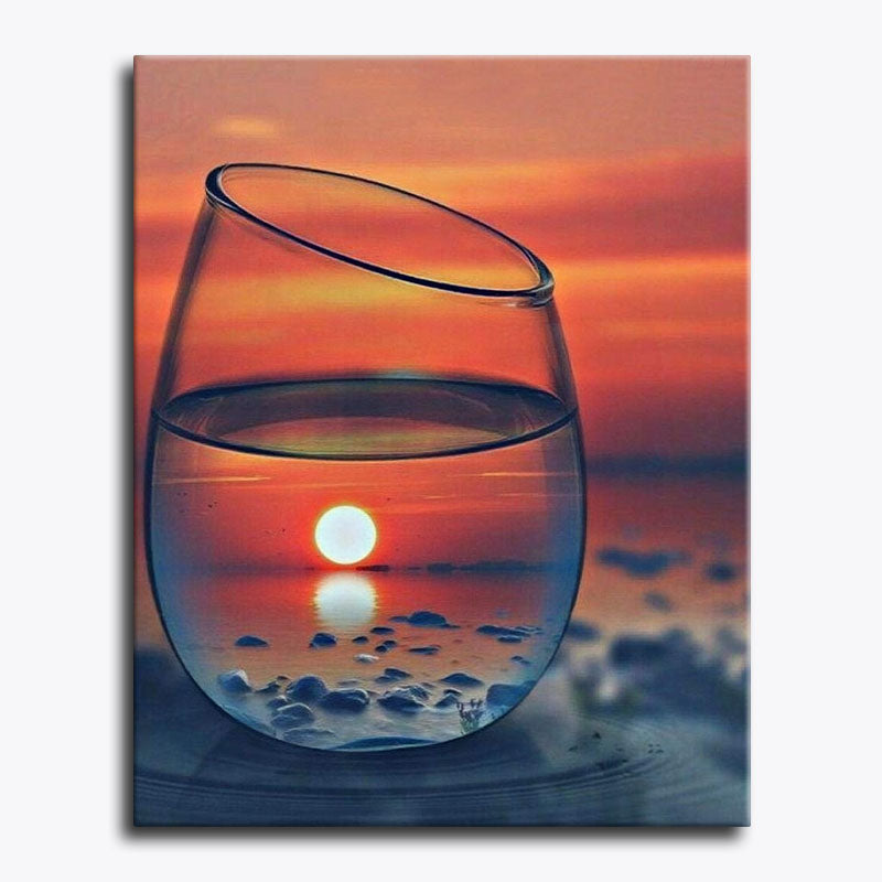 Canvas print of a wine glass with a sunset reflection on water.