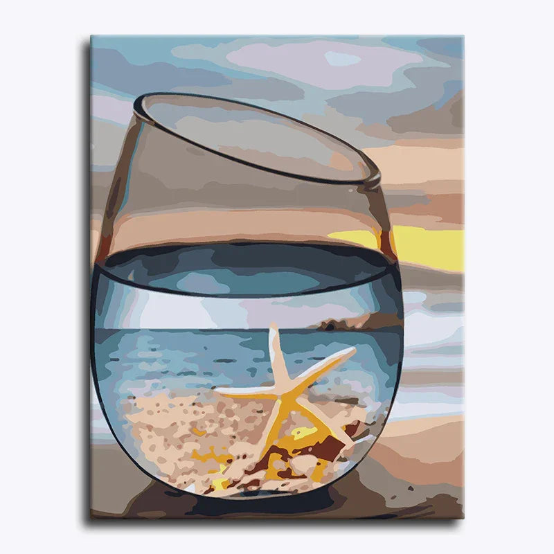 Canvas print of a glass with sand and a starfish on a beach scene.