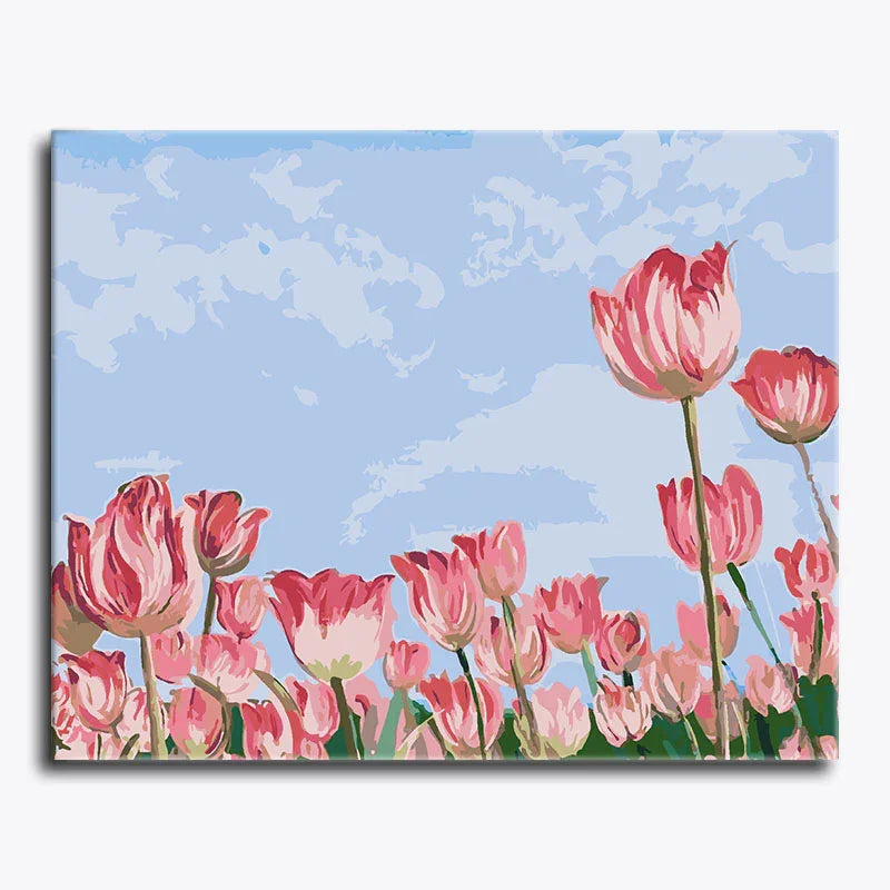 Canvas print of pink tulips against a blue sky with white clouds.