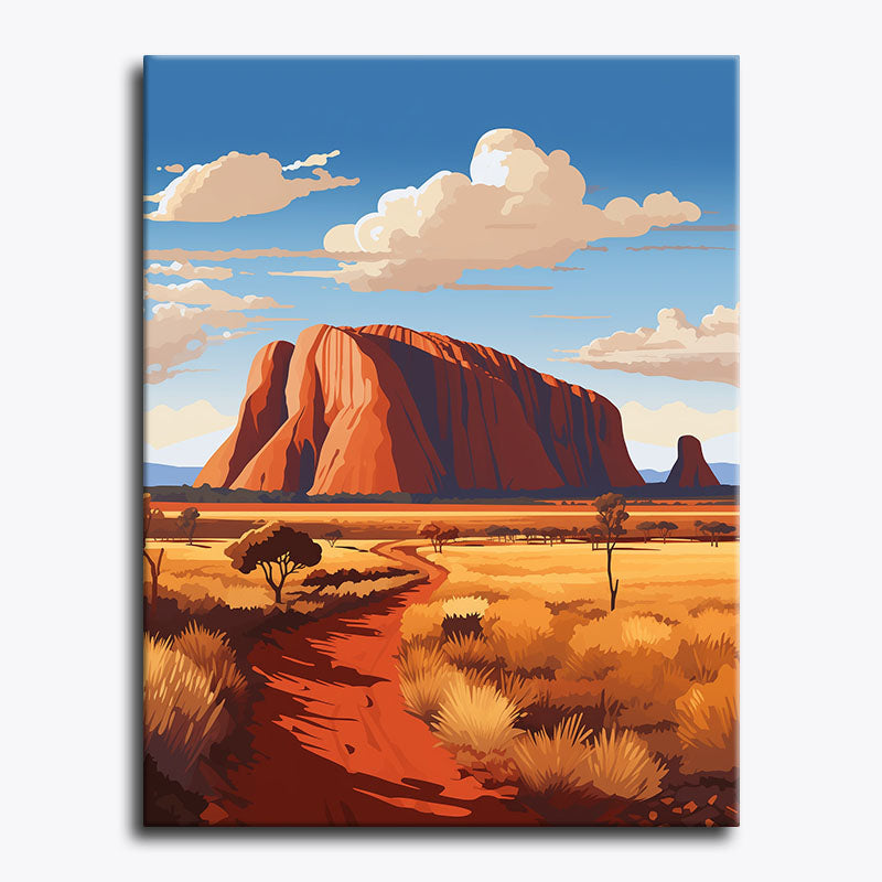 Desert landscape with a large red rock formation and a clear blue sky.
