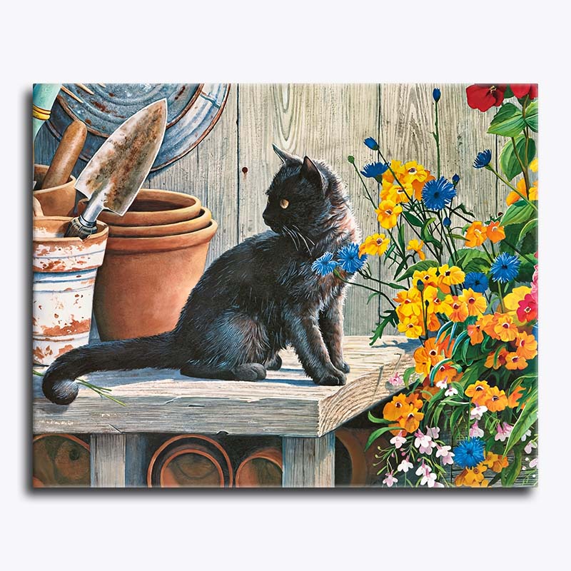 Black cat sitting on a rustic wooden table beside terracotta pots and bright garden flowers – paint by numbers canvas.