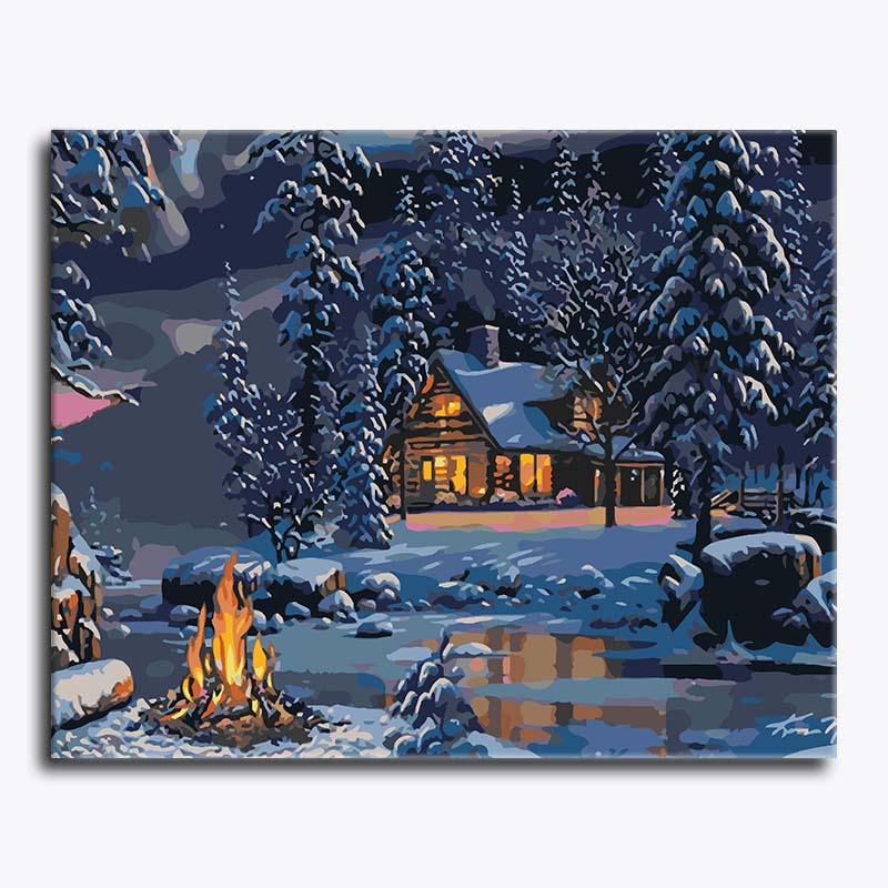 Winter scene with a cabin, fire, and snow-covered trees