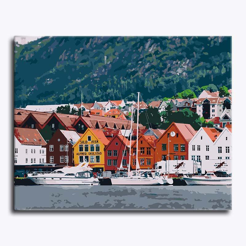 Colorful waterfront scene with houses and boats in a coastal town.