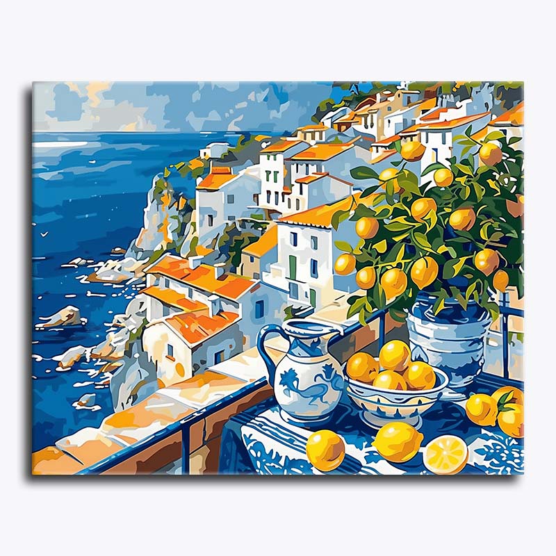 Canvas print of a coastal scene with buildings, lemons, and a pitcher.