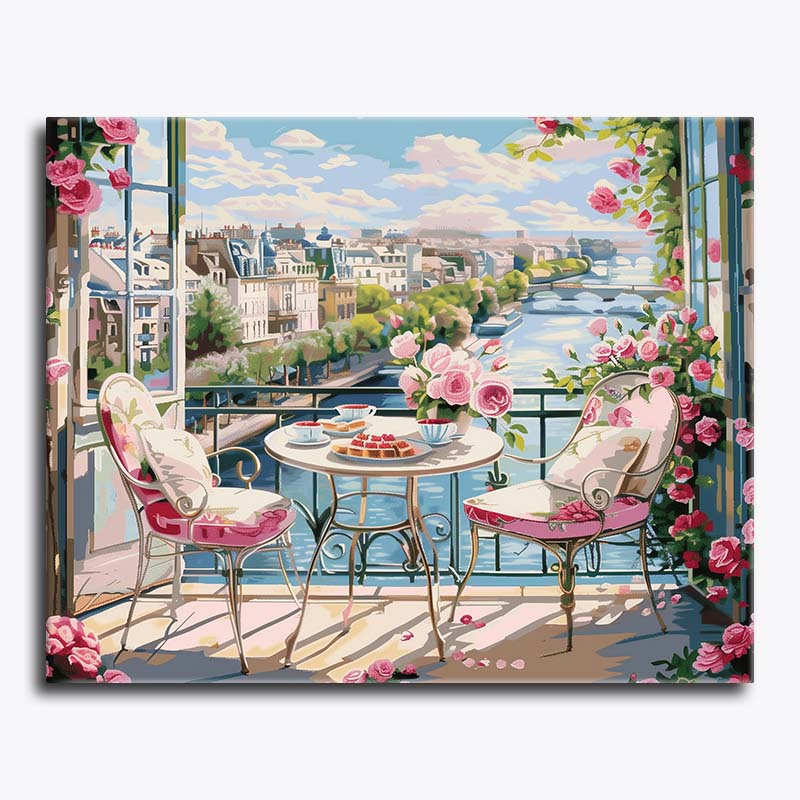 Painting of a balcony with pink chairs, table, and flowers with a cityscape view.