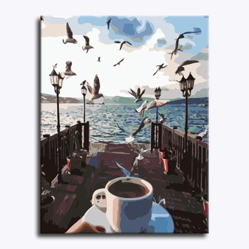 Canvas print of a coastal scene with birds, a cup of coffee, and a guitar.
