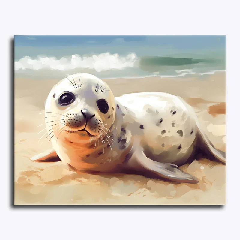 Seal lying on a sandy beach with a clear sky