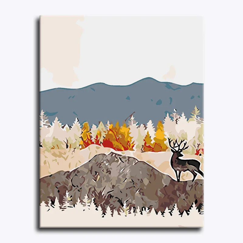 Canvas print of a deer in a forest with mountains and a blue sky.