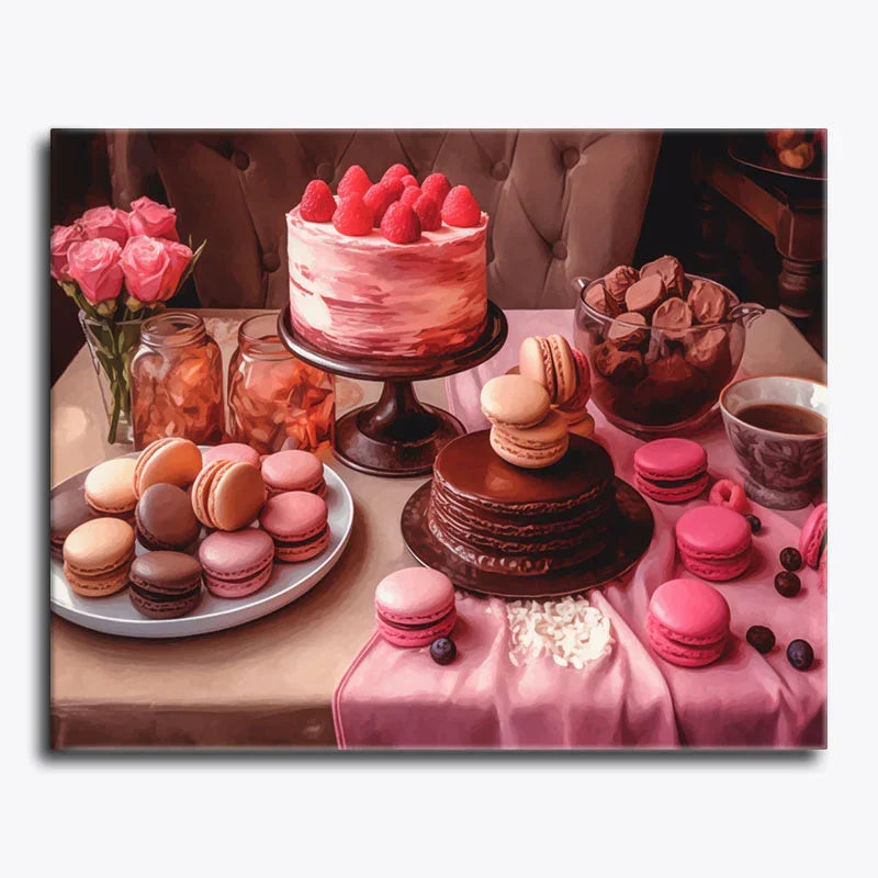 Table with pink cake, macarons, and coffee on a white background