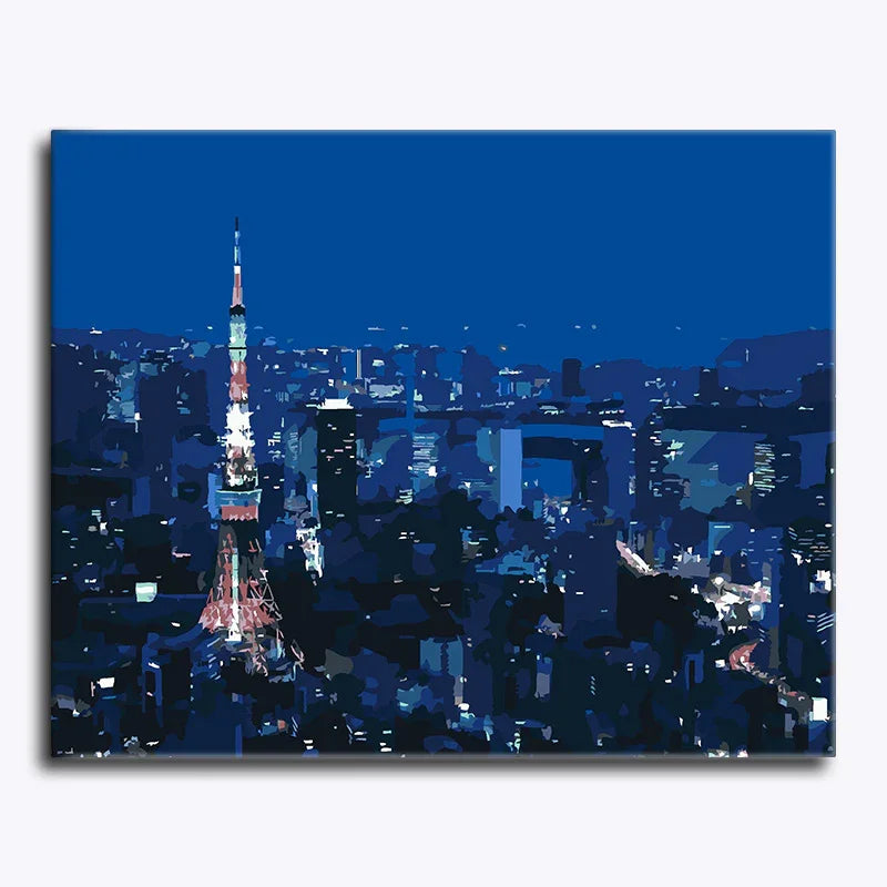 Cityscape at night with a prominent tower illuminated against a dark blue sky.